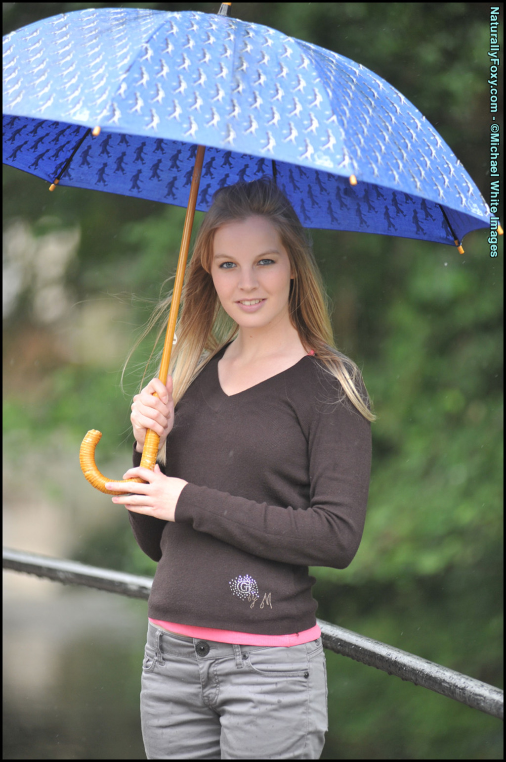 Blonde Girl Next-door Type Holds An Umbrella