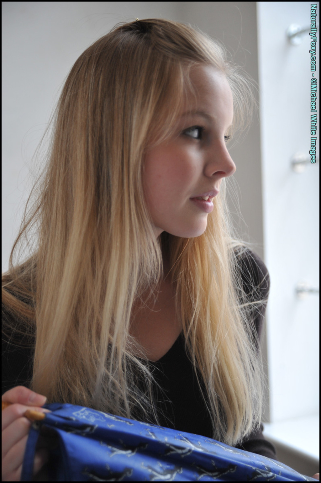 Blonde Girl Next-door Type Holds An Umbrella